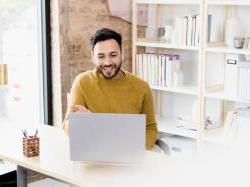 Business man sitting at desk working on computer